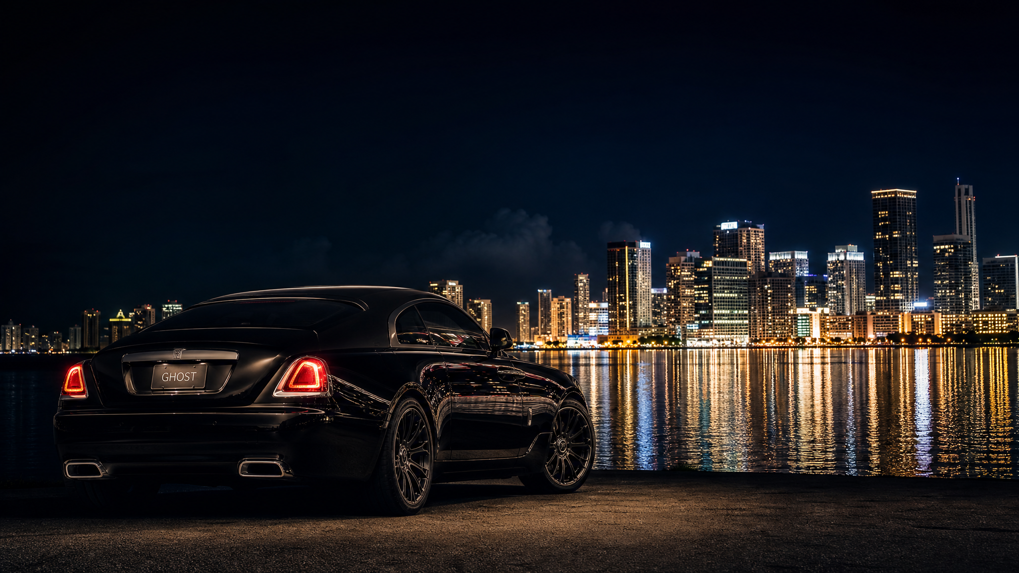 Luxury coupe with the Miami skyline at night